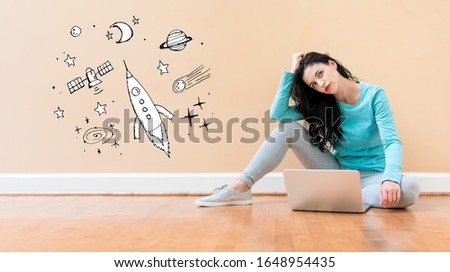 Dream of space and rocket with young woman using a laptop computer