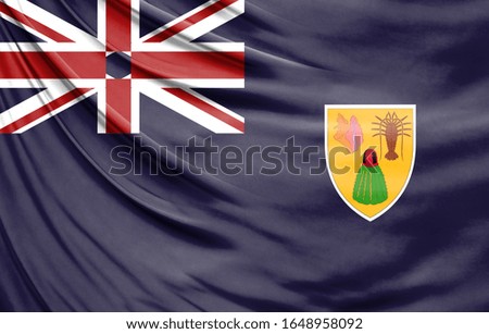 Realistic flag of Turks and Caicos Islands on the wavy surface of fabric