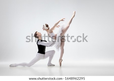 Kiss. Graceful classic ballet dancers dancing isolated on white studio background. Couple in tender white clothes like a white swan characters. The grace, artist, movement, action and motion concept.