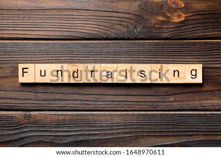 fundraising word written on wood block. fundraising text on table, concept. Royalty-Free Stock Photo #1648970611
