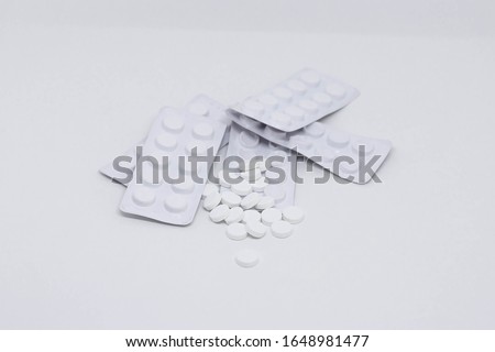 Pills on a white background. The cure for disease or epidemic. From a headache, cough, temperature.