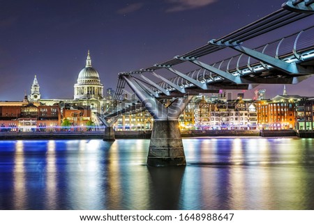 St Paul's catheral at night in London with Millenium Bridge leading to the cathedral on thames