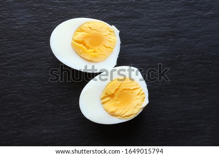 Photography of a cut boilled egg on a slate for food background
