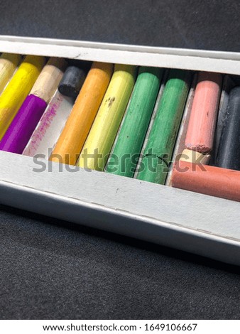 pastel for drawing different colors in boxing on a black background