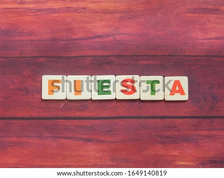 Spanish word Fiesta meaning Festival on wood background