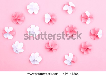 March 8 greeting card with paper flowers on a pink background