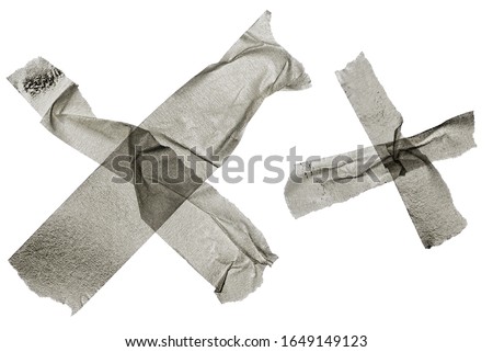 white crepe tape strips isolated on white background forming the letter x and overlapping each other, long sticky tape shapes with ripped paper edges, design elements for your poster or collage idea.