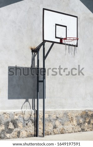 Basketball board on empty playground.