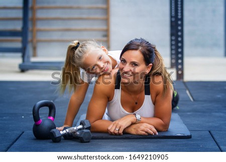 happy mother and daughter in the gym to do exercise Royalty-Free Stock Photo #1649210905
