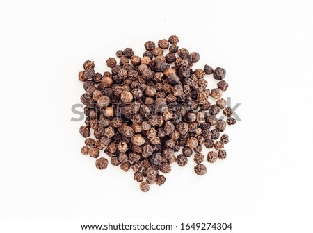 Small pile of black pepper isolated on white background. Top view. (dried seeds of Piper nigrum). Peppercorns, Black peppercorn