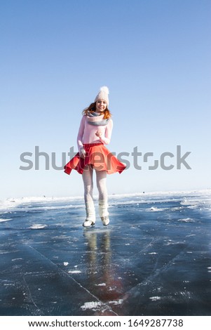 young girl skates on Baikal ice