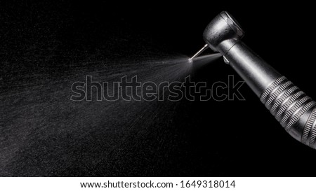 Water being sprayed out from a dental highspeed handpiece Royalty-Free Stock Photo #1649318014