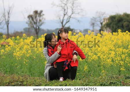 A mother and daughter playing happily in the fields of spring Royalty-Free Stock Photo #1649347951
