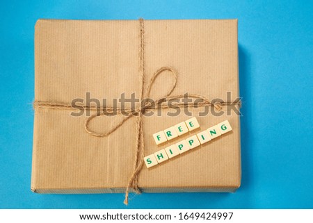 cross word free delivery on the brown paper wrapped parcel on blue background