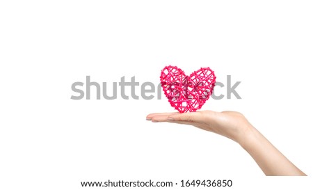 Hand with pink wooden heart, handmade gift. Isolated on white background. Copy space, template.