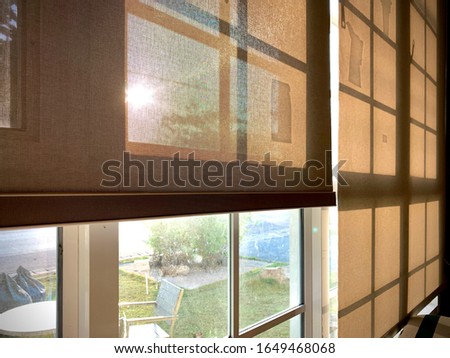 Modern blinds traditional home decoration. Sunlight coming through blinds by the window. Curtain at a window overlooking the highest Building of downtown outside. Royalty-Free Stock Photo #1649468068