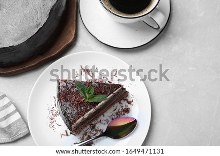 Tasty chocolate cake on grey table, flat lay