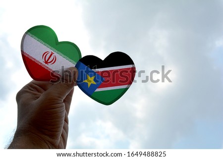 Hand holds a heart Shape Iran and Sri Lanka flag, love between two countries