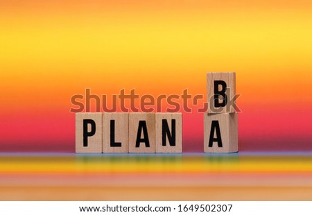 cube dices changes the word Plan A to Plan B. Business strategy and marketing concept, Wooden letters, with word PLAN B on colored background