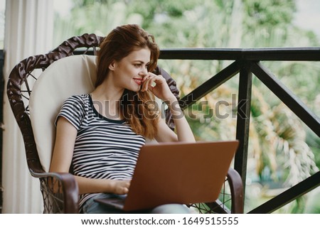young woman with laptop outdoors