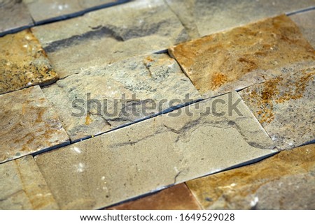 Closeup detail of limestone tiled wall of floor.