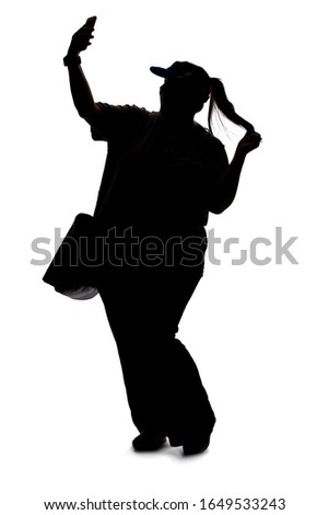Silhouette of a curvy or plus size woman on a white background.  She is takign a selfie or streaming video online for social media as an influencer