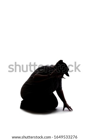 Silhouette of a curvy or plus size woman on a white background.  She is kneeling down and searching for something on the ground