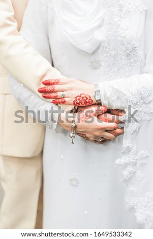 Close up shot of bridegroom hold hands together