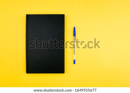 Sketchbook, notebook and pen flat lay on colorful yellow background top view with copy space. School and office supplies layout. Back to school and business concept. Web banner template. Stock photo.