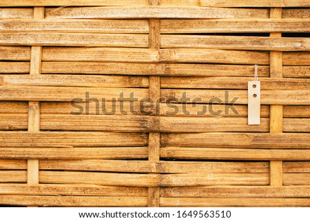 Natural bamboo plank fence background with price tag. Background with price tag.