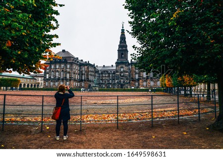 Tourist taking picture of old european building. travel concept