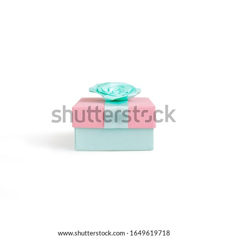 Beautiful gift box with ribbon isolated on white background. Bright mint and pink colors