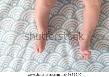 Newborn baby feet, barefoot with tiny toes in selective focus, family and maternity concept. Photo of newborn baby feet.