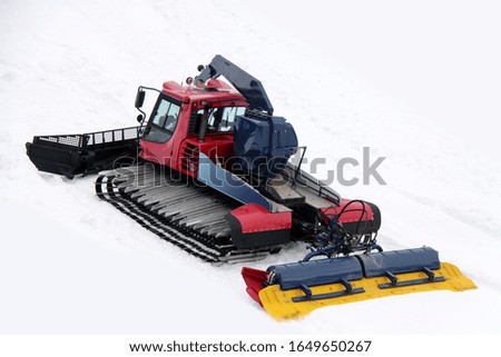 Snow groomer prepares the ski slope