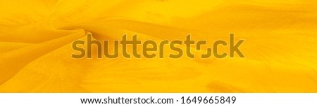 Background texture, yellow silk fabric with painted meadow flowers, colors between green and orange in the spectrum, the main subtractive color, painted like ripe lemons or egg yolks.