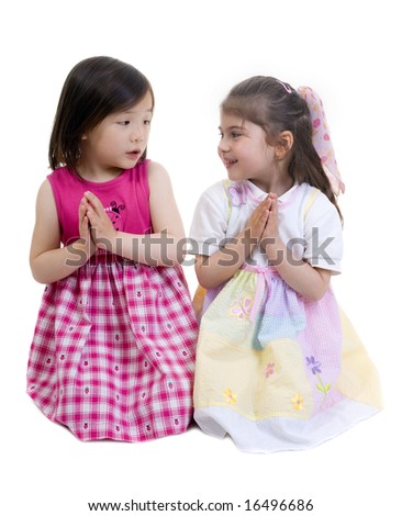 Two young girls kneeling and sharing a prayer