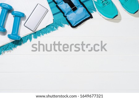 Fitness accessories, healthy and active lifestyles concept background with copy space. Lay flat products with punchy pastel colours and frame composition. Image taken from above, top view.