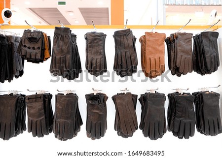 Leather gloves on the stand close-up. Marketing concept. Skin texture. Textile design. Decoration