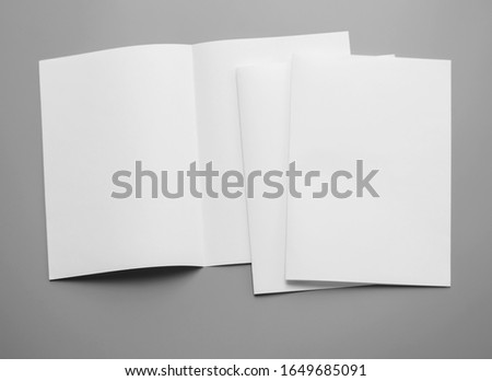 Poster mock-ups paper, white paper isolated on gray background, Blank portrait paper A4. brochure magazine , can use banners products business texture background for your. newspaper