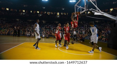 Basketball players on big professional arena during the game. Tense moment of the game. 