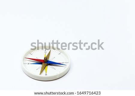 compass with needle on white background studio light