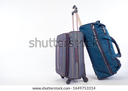 Bags for travel. Suitcases for personal items on casters. Two bags ready for the trip. Suitcases on a white background. Bags are ready to be sent to the airport. Concept - travel together