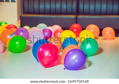 Different color balloons on the floor . Flat lay of colorful balloons . holiday, children's party, a games room, a box filled with small colored balls