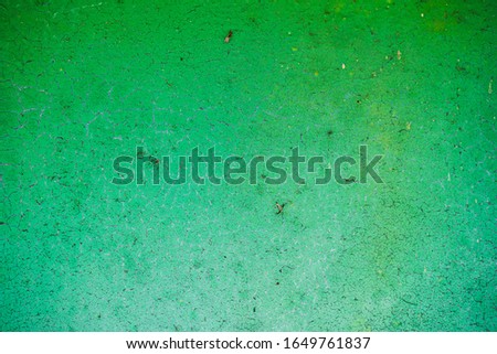 Background of peeling green paint and rusty old metal.