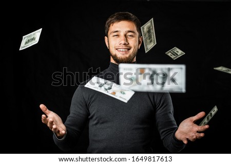 Businessman under a lot of falling banknotes