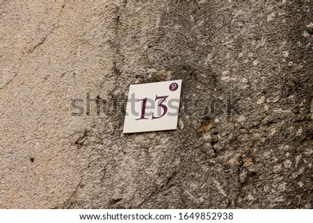 Number 13 plate on a wall