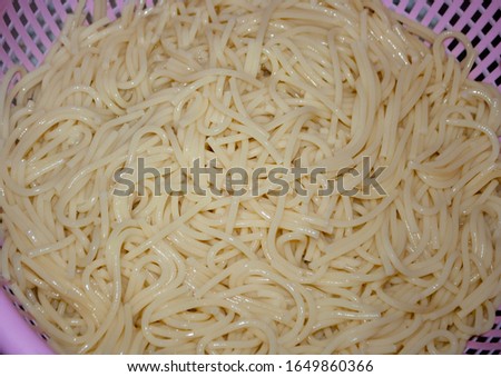 Close-up of Spaghetti in pink colander. The making spaghetti