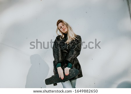 Blonde young woman posing for photo and looking at camera