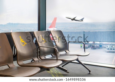 Empty disabled seats at an airport in the waiting area before boarding.