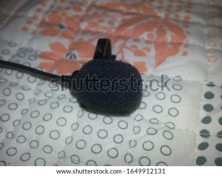 lavalier microphone Clip microphone lay down on bed sheet -image